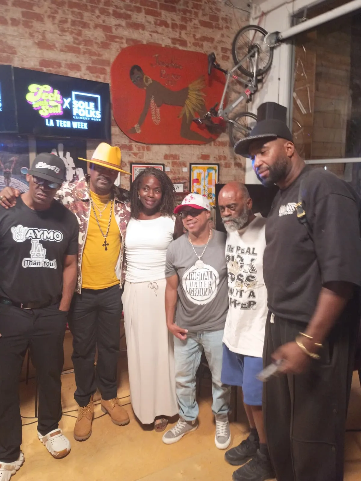 Panelists and the host pose on stage
