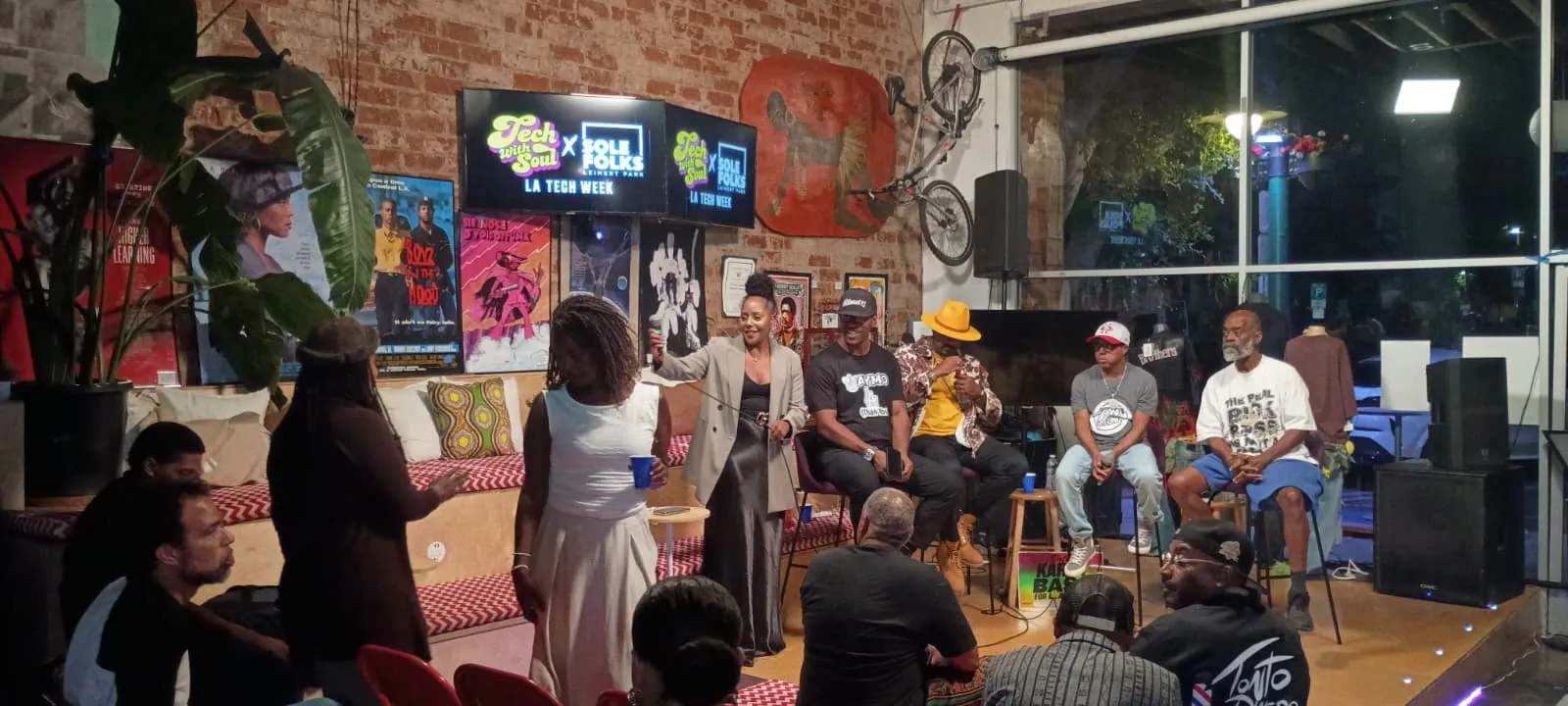 The audience watches the panel from the floor